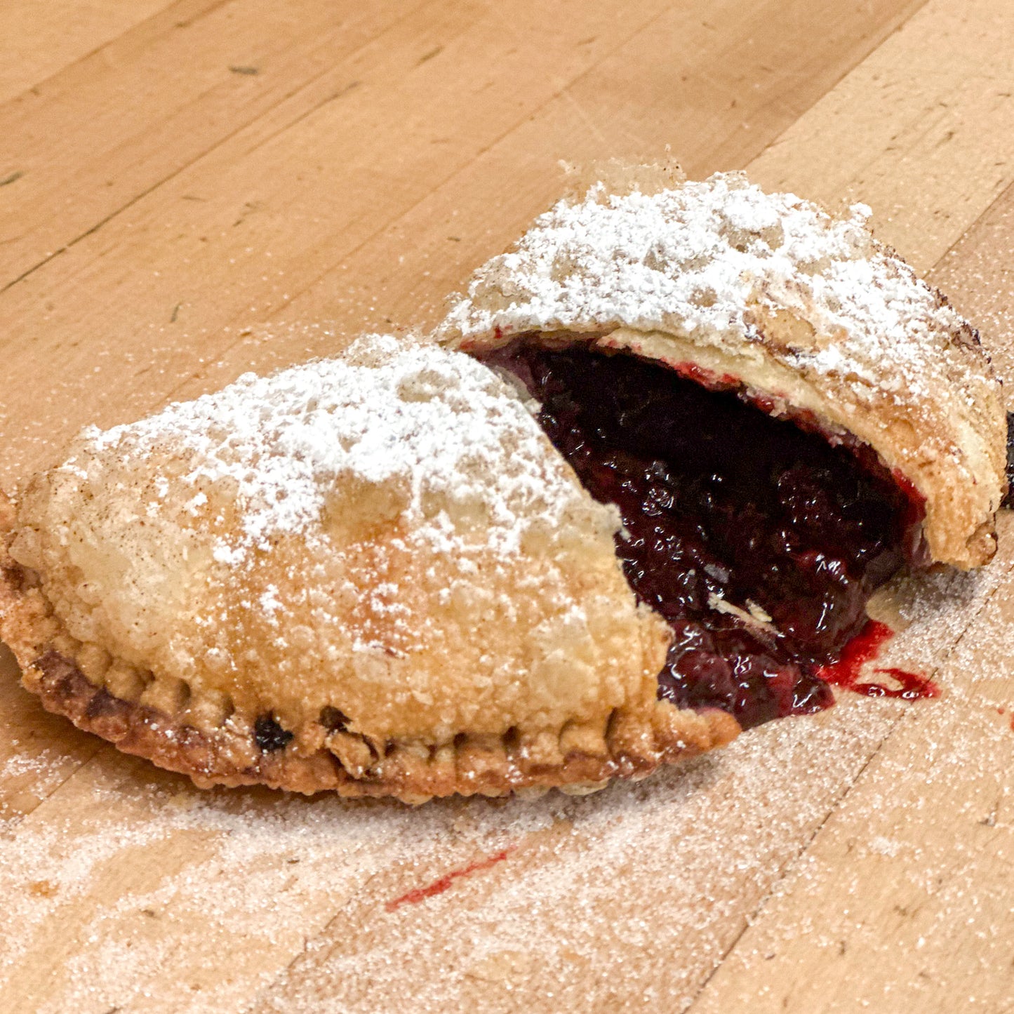 A fried flaky marionberry hand pie with marionberry pie filling.